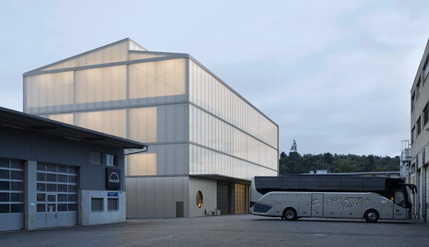 modern design building, large entrance, double storey, glass panels, white exterior, parking area