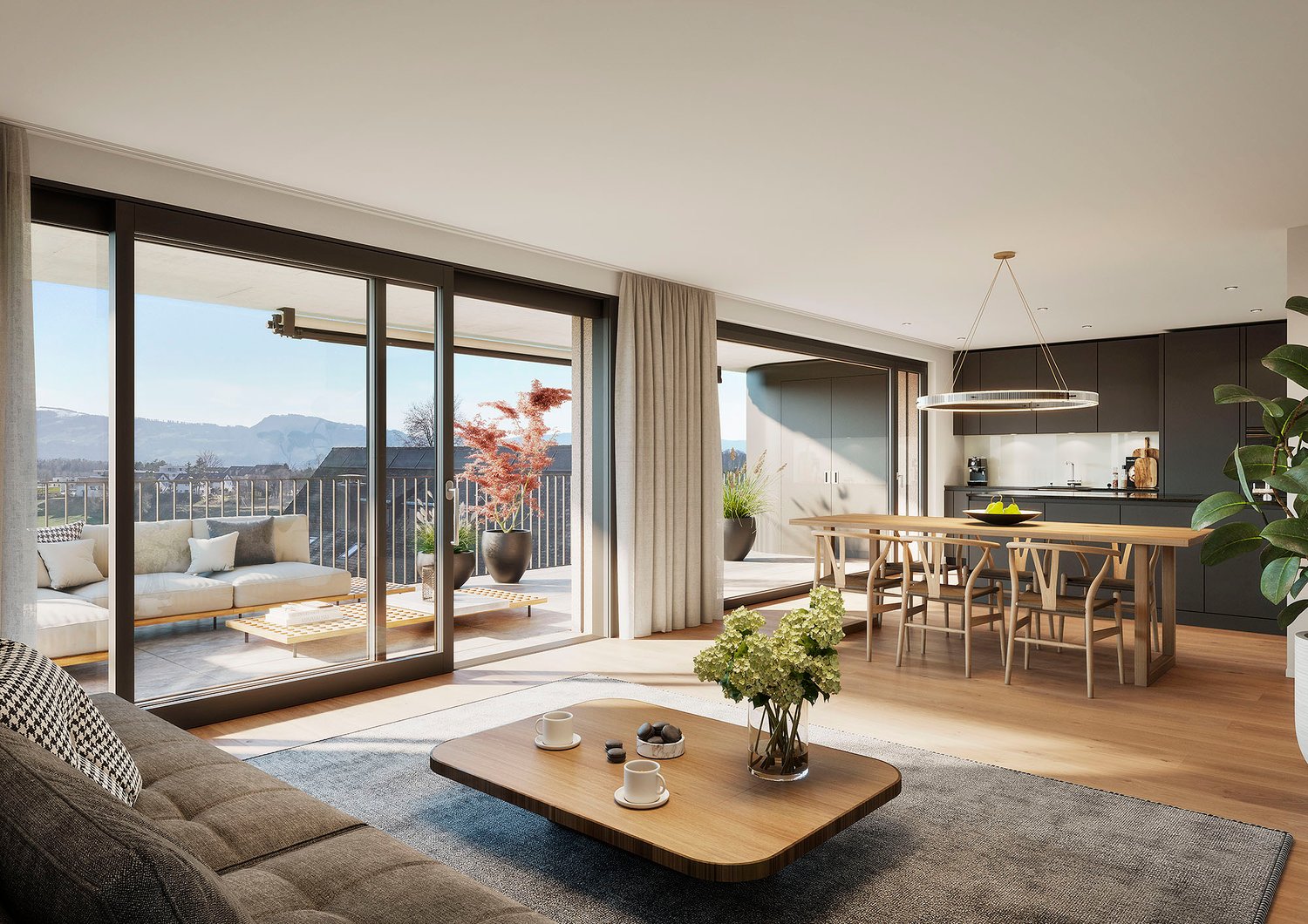 Spacious open-plan living area with large sliding glass doors leading to a balcony, offering a scenic view of the mountains. The room features a comfortable sofa, a wooden coffee table, and a dining area with a wooden table and chairs. The kitchen is visi