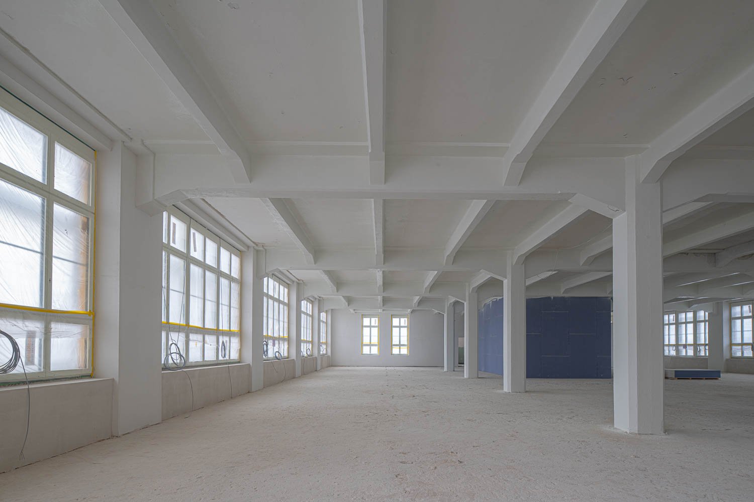 Empty room with white walls, white ceiling, glass windows, industrial style