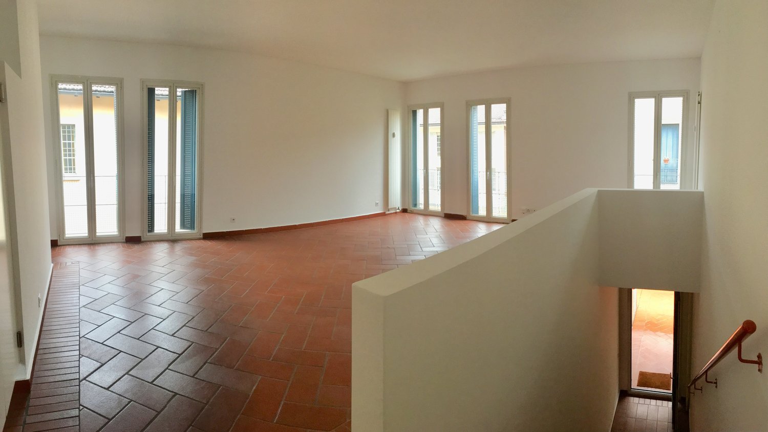 tiled floor, white walls, large windows, balcony