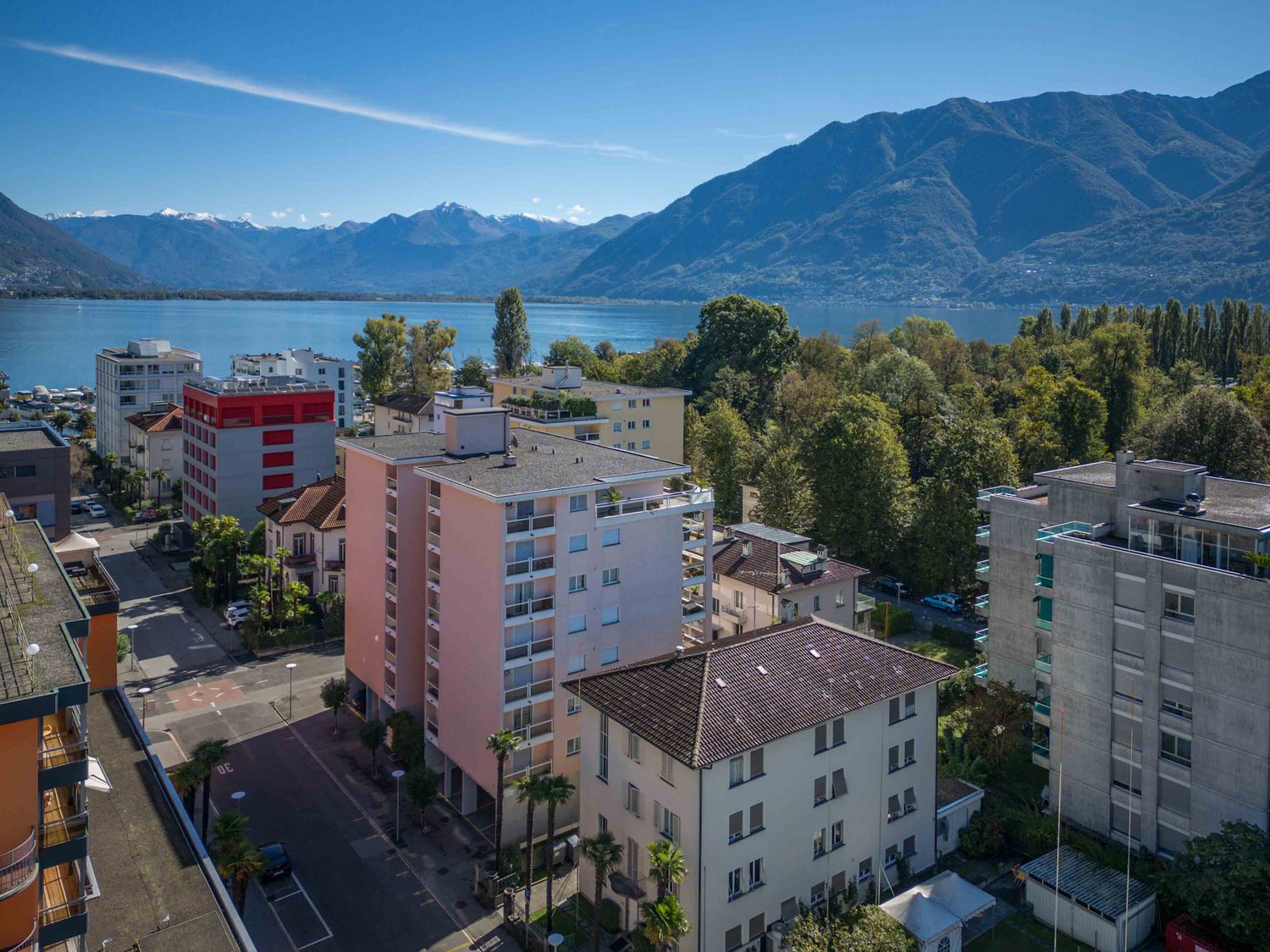 Buildings in a town near a lake and mountains