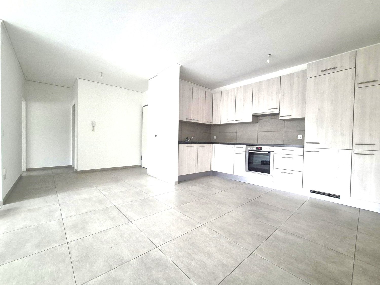 empty kitchen with tiles, modern cabinets, white walls, stainless steel faucet, gas oven