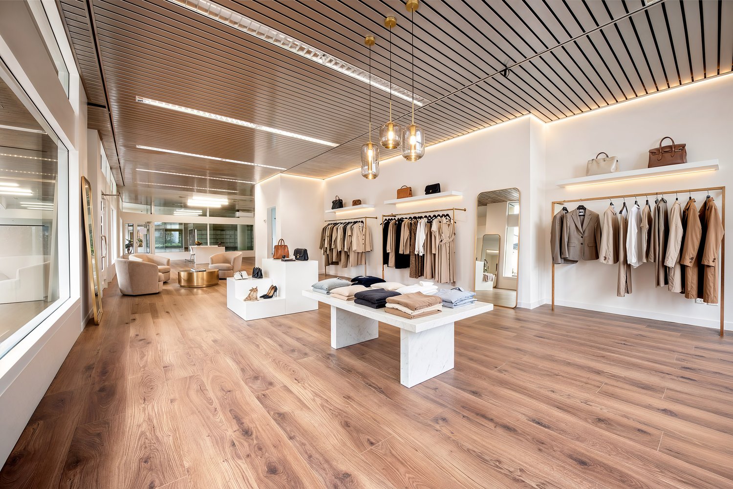 modern interior design, wooden floor, white walls, clothing racks, display tables, lamps