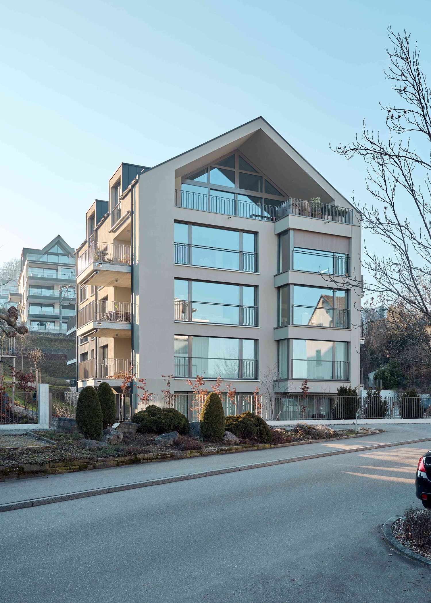 modern architectural style, beige color, large glass windows, balconies on every floor