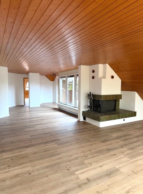 empty room with fireplace and sliding doors