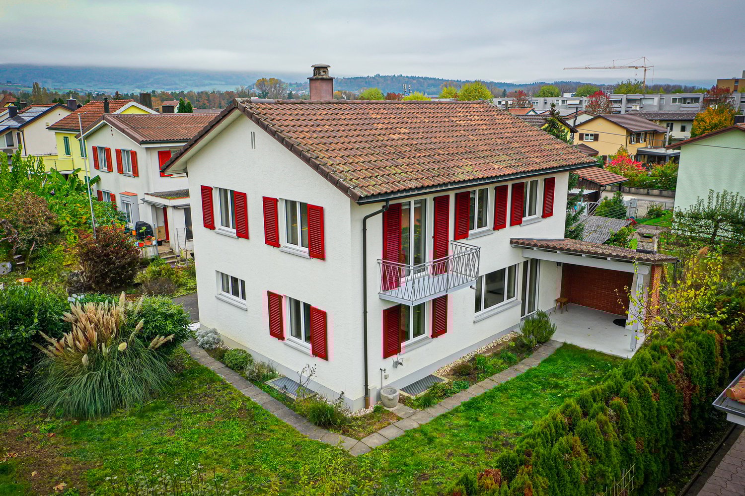 2 story house, white wall, red roof, red windows shutters, terrace, garden, driveway