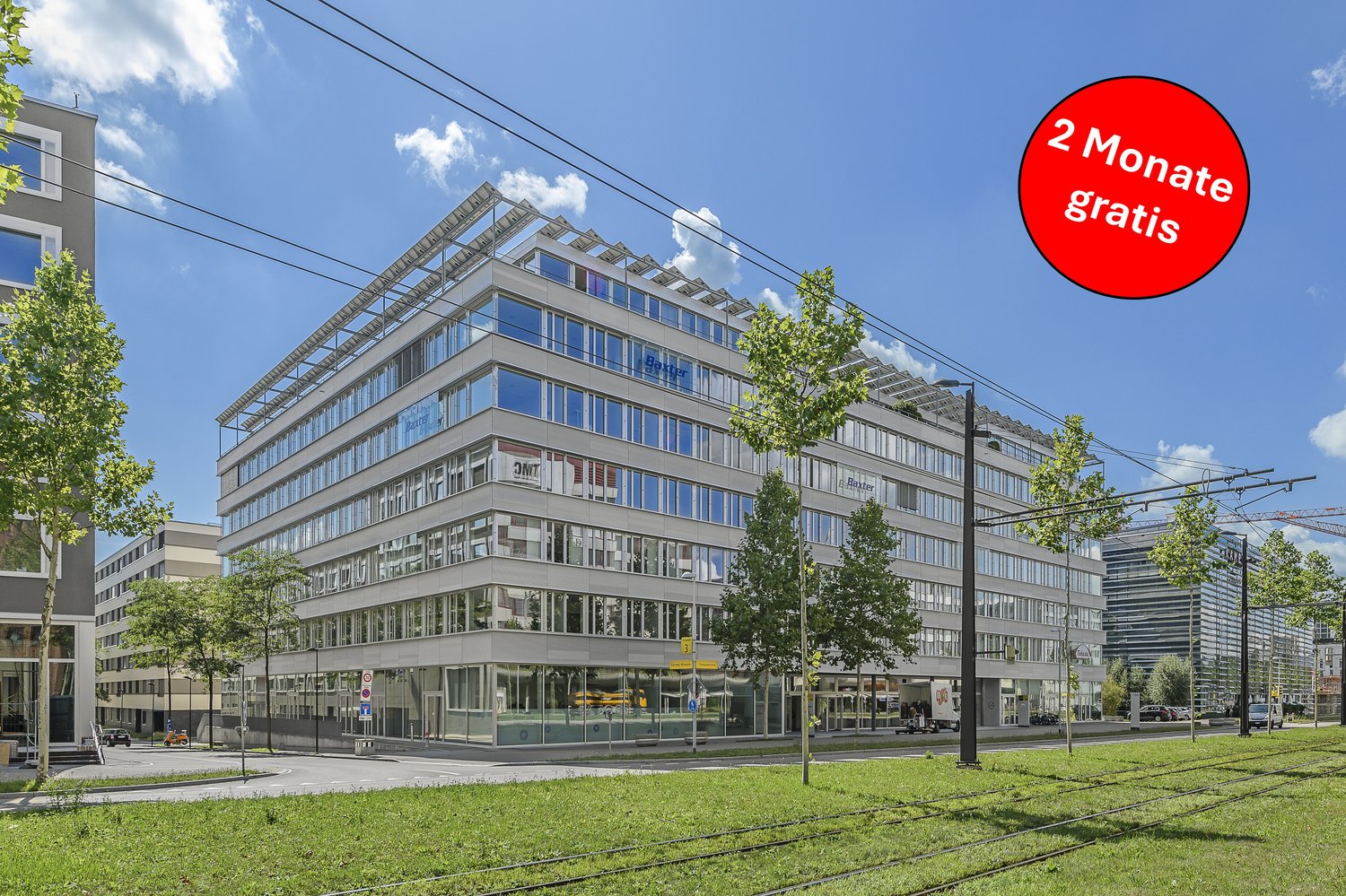 modern office building, glass windows, solar panels on the roof, street lights, trees, tram tracks