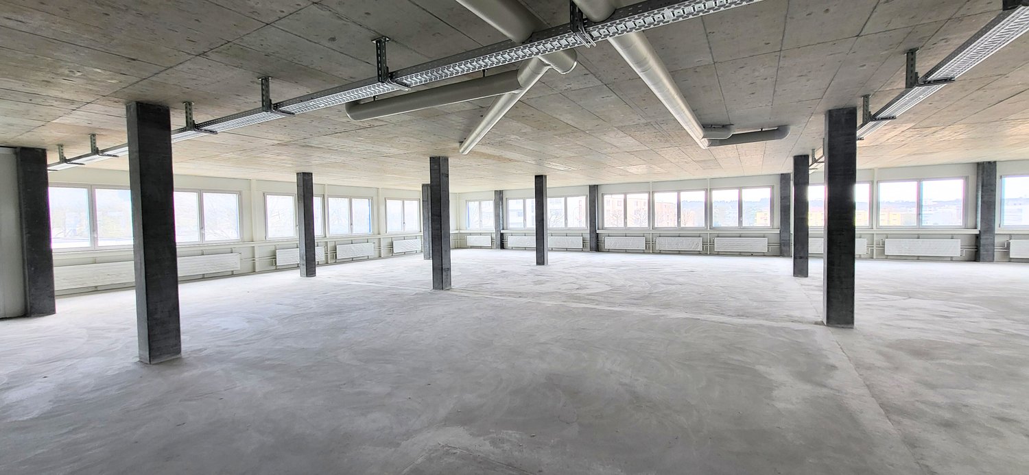 large open room, lots of windows, industrial look, exposed pipes