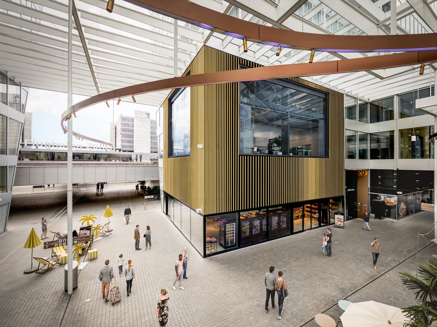 modern urban plaza with a glass and steel structure, pedestrian walkway, glass wall, shops on the ground floor, open space, yellow and white chairs and umbrellas