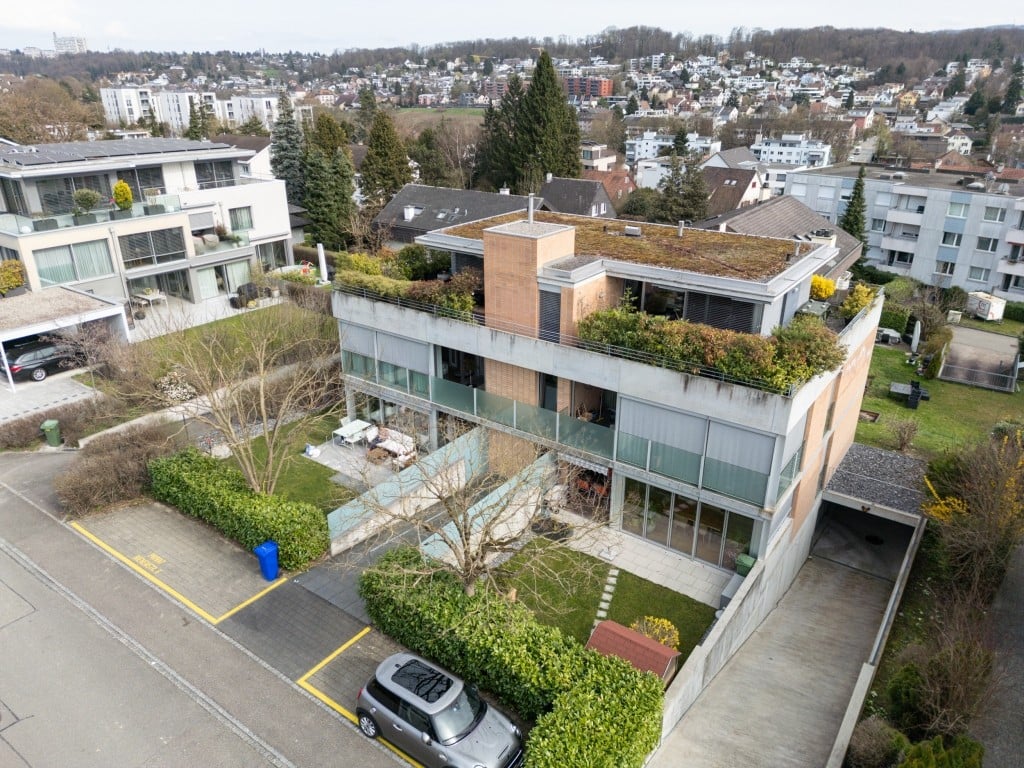 3 story house, green roof, glass balcony, garage, car parked