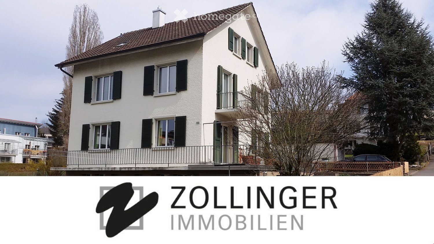 2-storey house, white walls, brown roof, 5 windows, balcony
