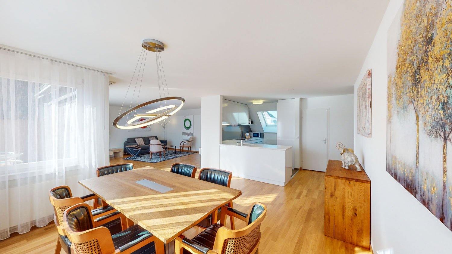 dining table with 6 chairs, round light hanging from ceiling, open kitchen, balcony, large windows