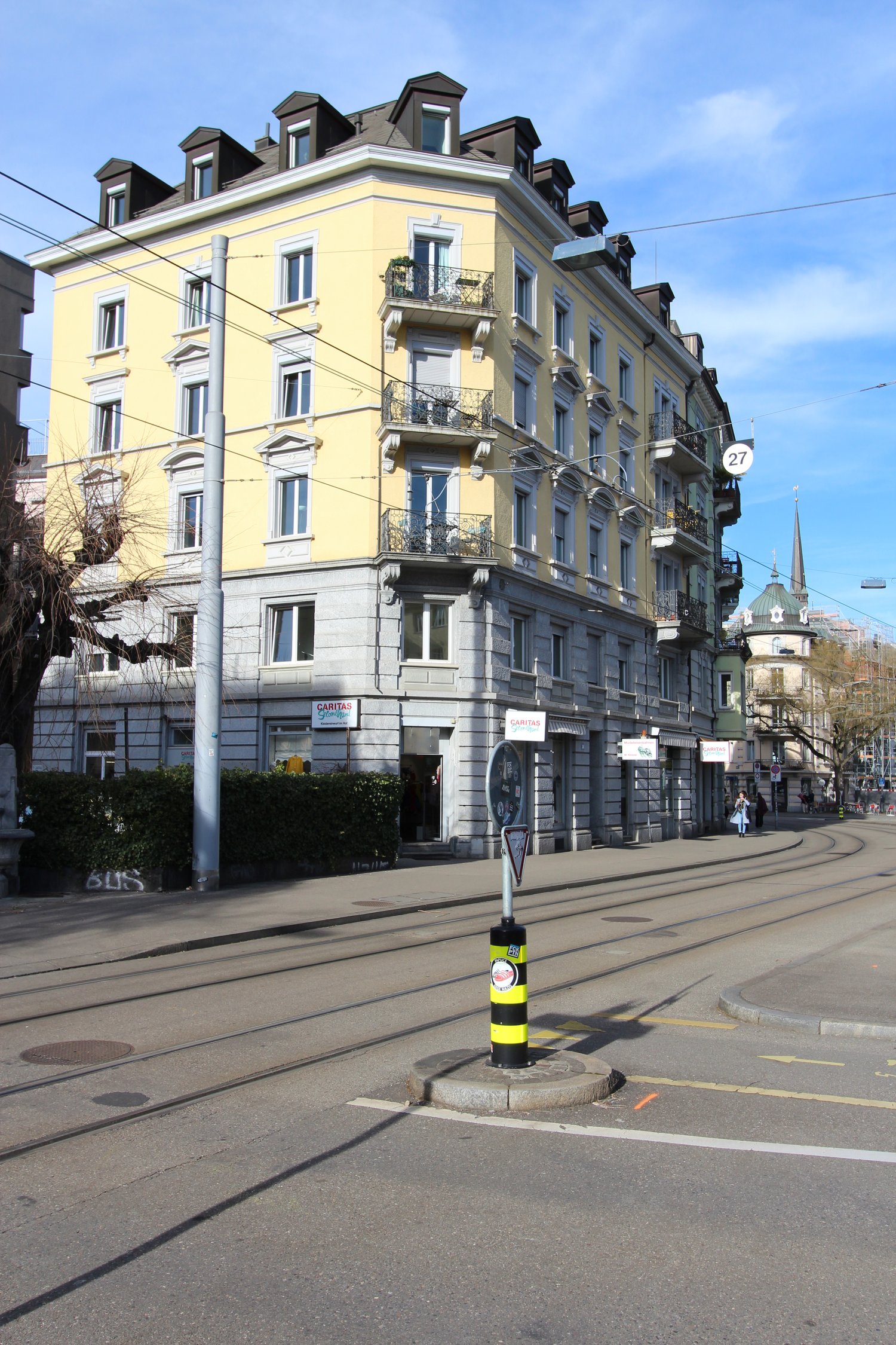 yellow building, multiple balconies, street, tram tracks