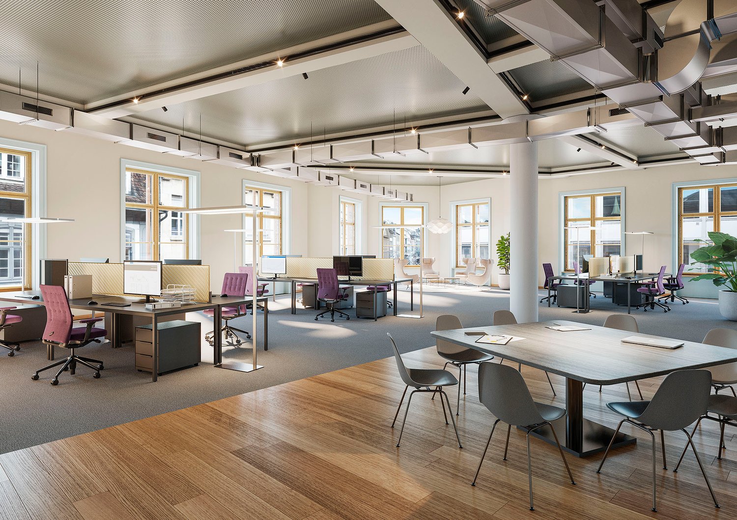 Large open-plan office space with high ceilings, large windows, and modern furniture. The space features workstations with computers, conference tables, and a mix of seating options. The decor is minimalist with a neutral color palette and wooden flooring