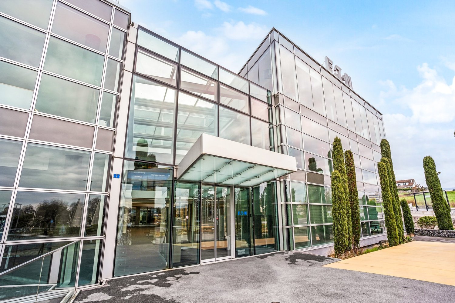 modern office building, glass facade, large entrance, glass doors, glass walls, modern design