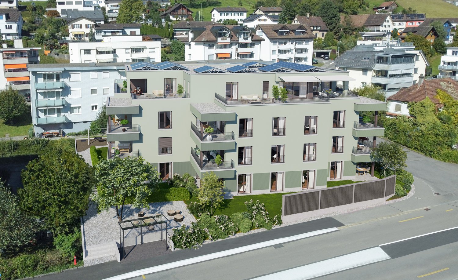 A modern apartment building with multiple balconies, solar panels on the roof, and a green garden in front.