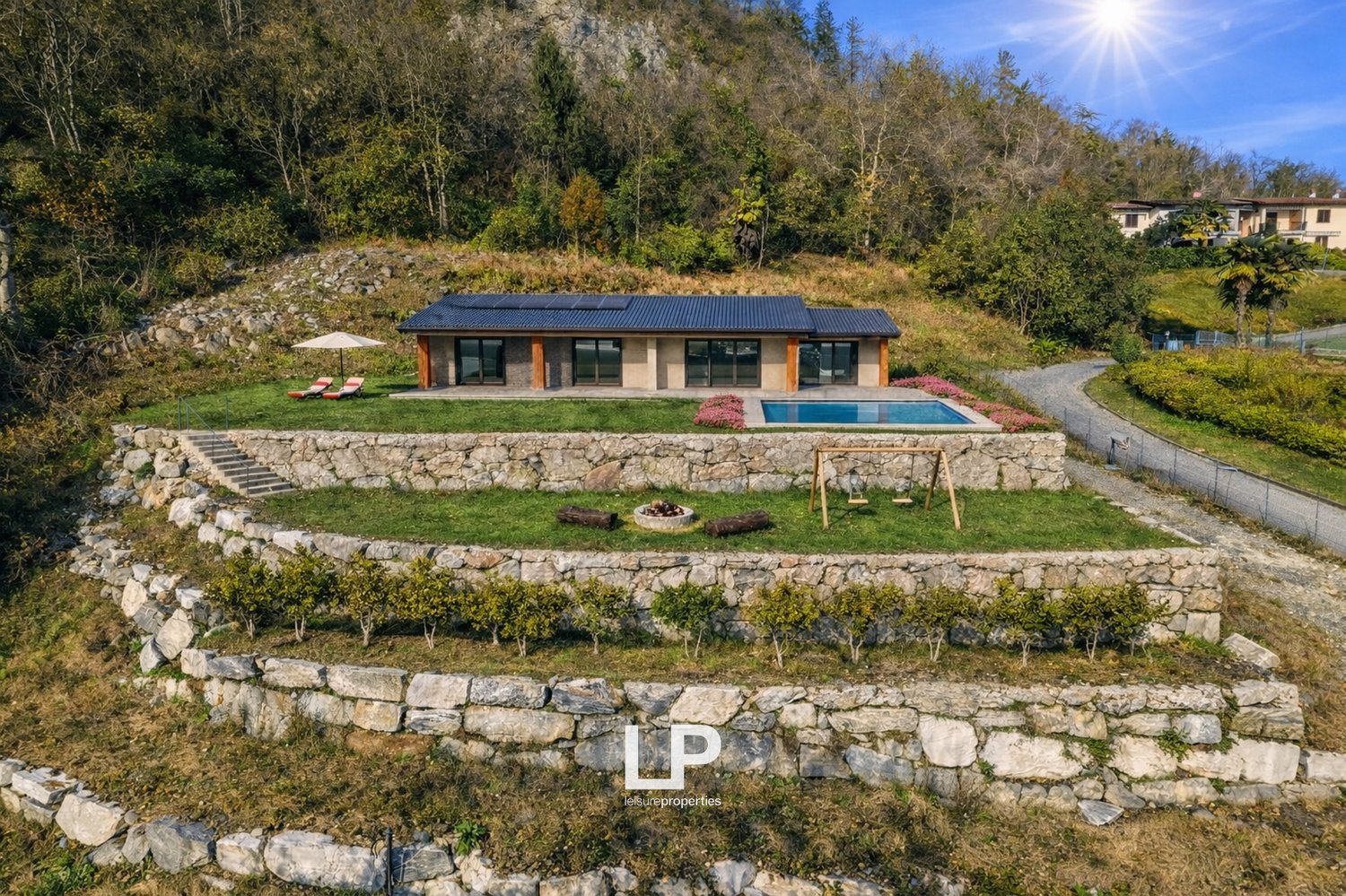 Detached house with solar panels, swimming pool, landscaped garden with stone walls
