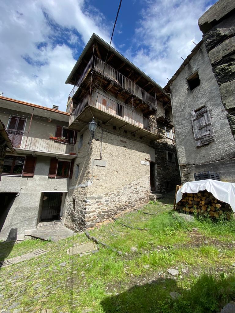 stone building, balconies, tiled roofs, two storeys