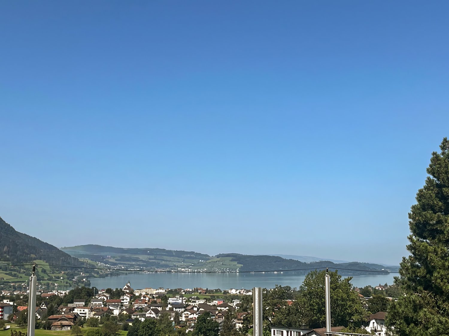 overlooking a village with mountains and a lake in the background
