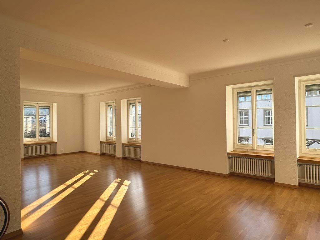 Open living space, hardwood floor, windows, view